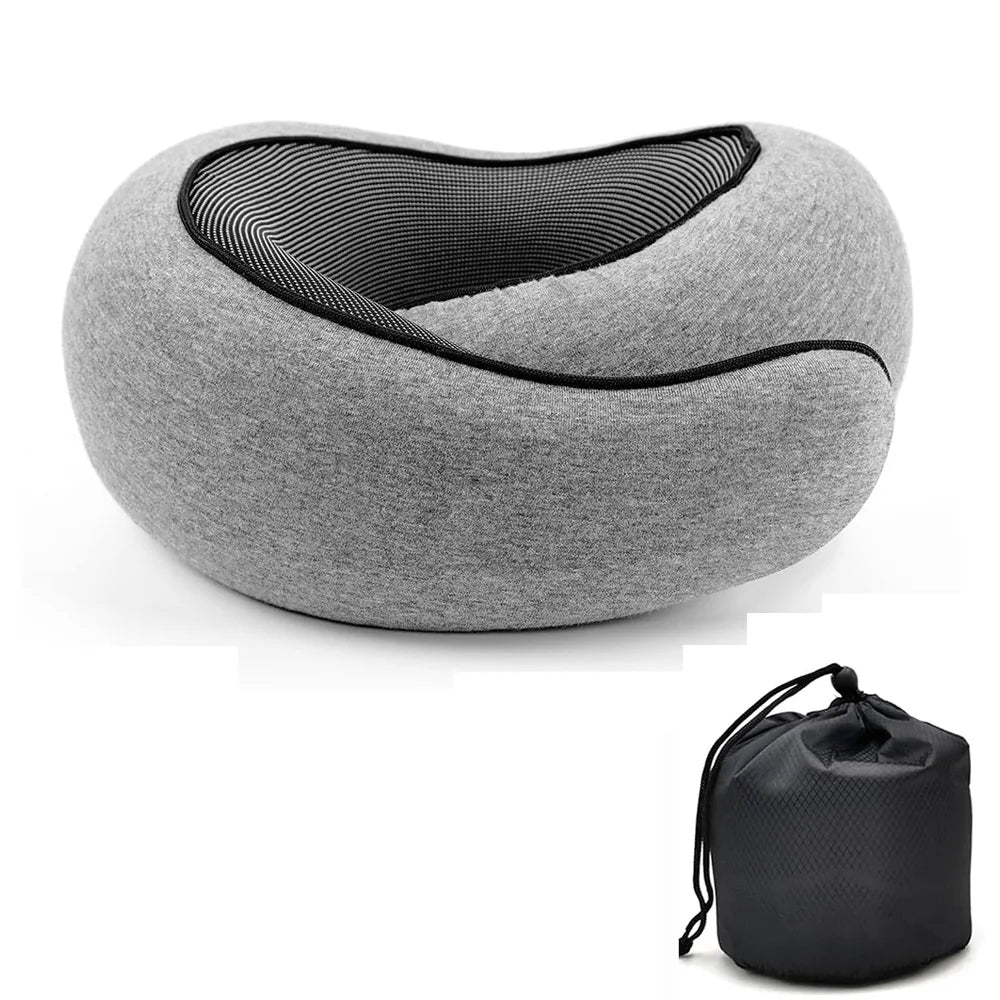 A gray contoured travel neck pillow with a black mesh interior, shown alongside its black drawstring storage pouch on a white background.