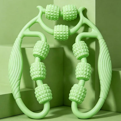 A mint green manual massage roller with textured cylindrical rollers and curved handles, displayed against a matching green geometric background.
