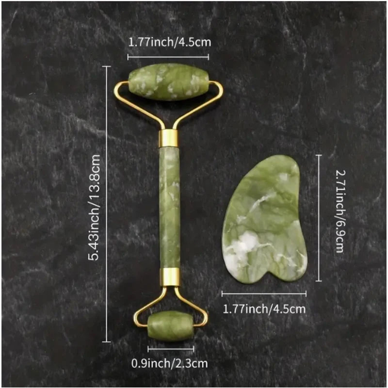 Green jade roller and gua sha tool with measurements on a dark surface