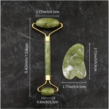 Green jade roller and gua sha tool with measurements on a dark surface