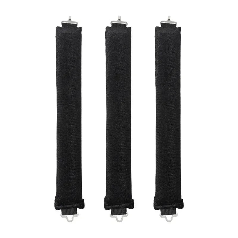 Three black hair rollers with white ends on a white background