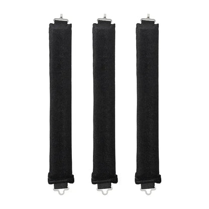 Three black hair rollers with white ends on a white background