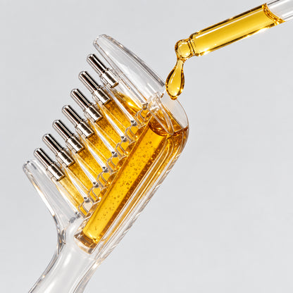 Scalp oil applicator comb shown with liquid and a dropper