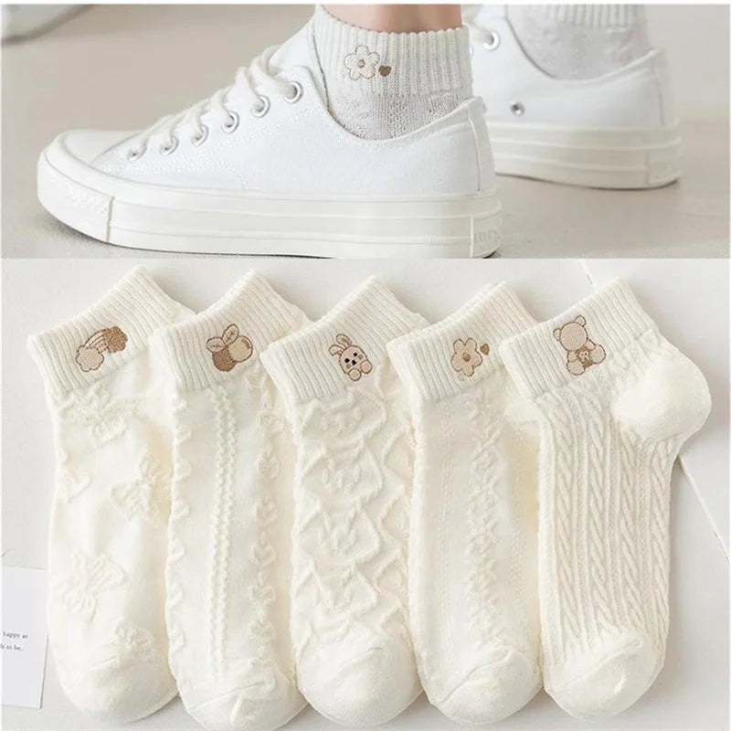 White cartoon ankle socks displayed below a photo of socks worn with white sneakers.