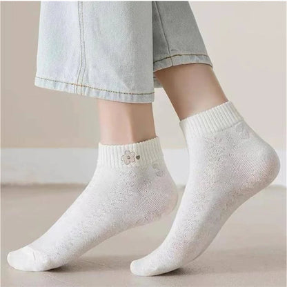 White socks with a subtle pattern worn by a person on a neutral background