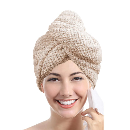 a women wearing a beige color towel wrap on her head