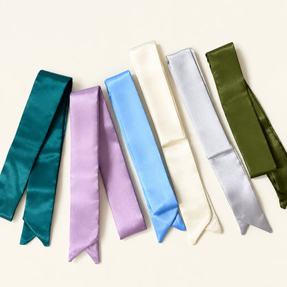 Set of colorful ribbons on a textured surface in the background.
