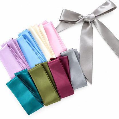 Set of colorful satin fabric samples with a silver ribbon on a white background