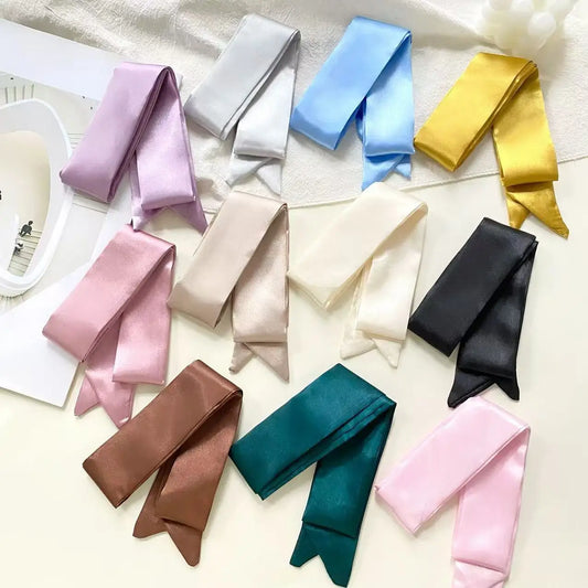 Collection of colorful satin ribbons on a light background