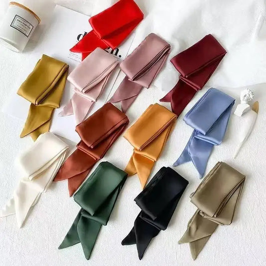 Collection of colorful scarves arranged on a white surface
