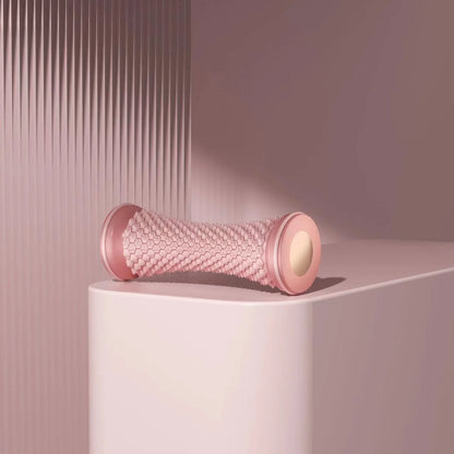 pink manual foot massage roller on pink surface